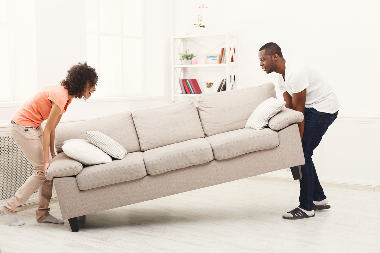 African-american-couple-placing-sofa-at-new-home
